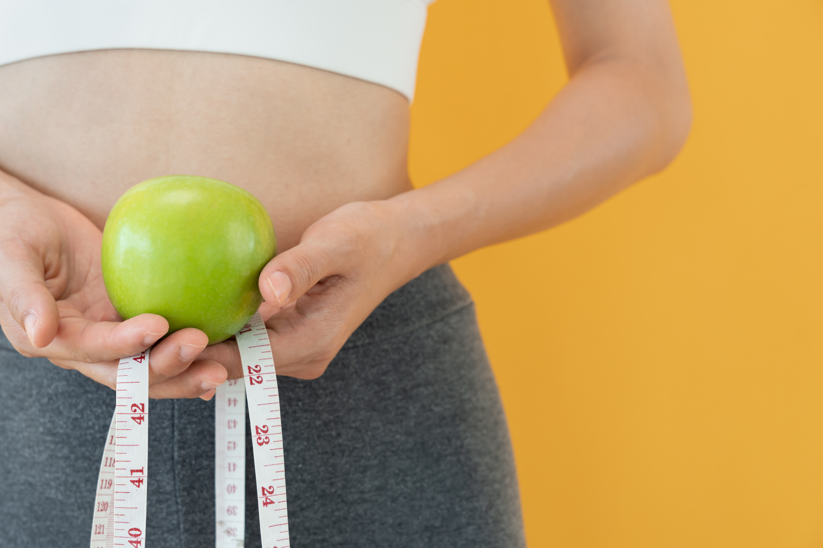 Diet and dieting. Beauty slim female body use tape measure on hand and choose healthy food. weight loss, lose, balance, control, reduce fat, low calories, routines, exercise.